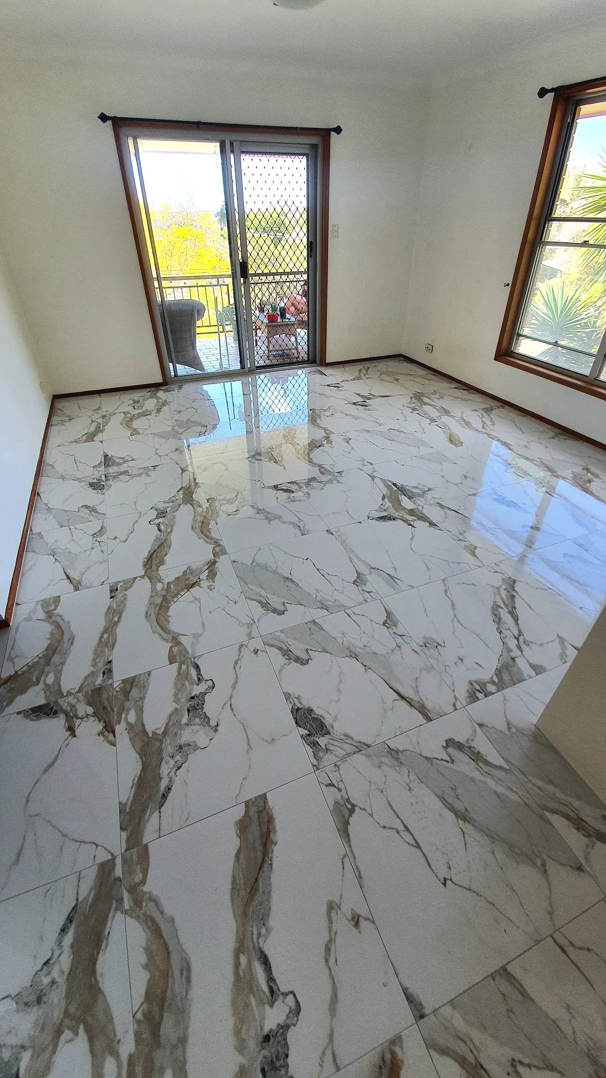 Bold gold-veined marble-look porcelain floor tiles in a living room