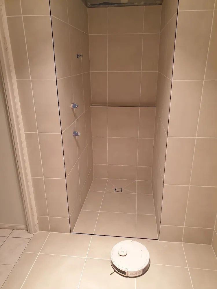 Freshly tiled bathroom shower and floor before fit-out
