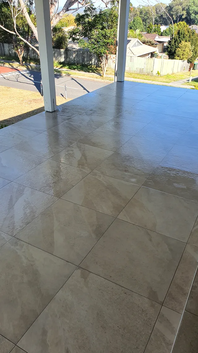 Elevated terrace tiled with large-format porcelain tiles with a view over the suburb